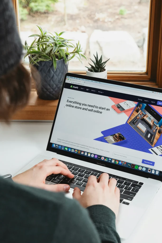 Person managing an e commerce website on a laptop, representing online retail compliance, digital platforms, and regulatory guidance in the UAE and GCC.