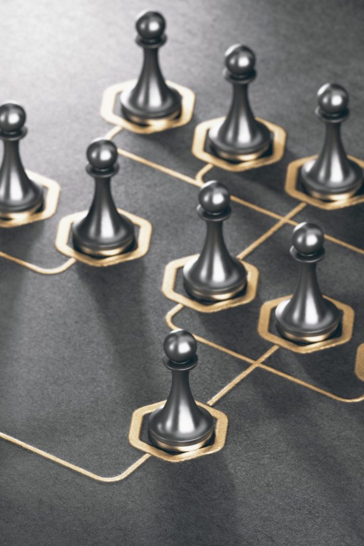 3D illustration of many pawns and golden organizational sheme over black background. Company hierarchy concept.