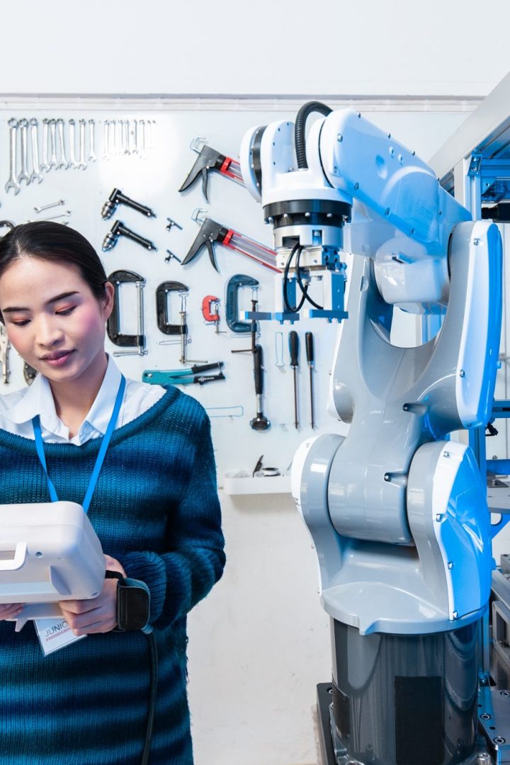 Asian Engineers Maintenance Robot Arm at Lab. they are in a High Tech Research Laboratory with Modern Equipment. Professional Japanese Development Engineer Testing an Artificial Intelligent.